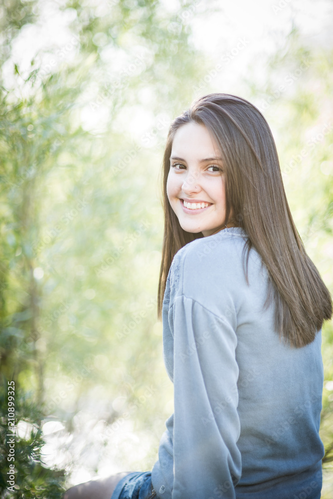 Beautiful teenage girl in a park setting Beautiful teenage girl in a park setting