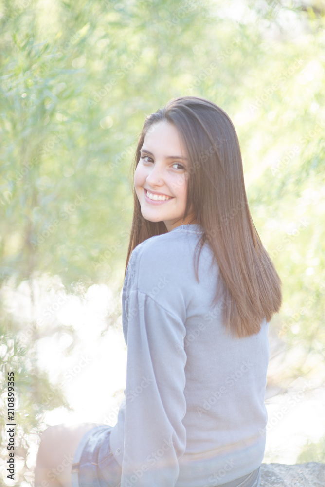 Beautiful teenage girl in a park setting Beautiful teenage girl in a park setting