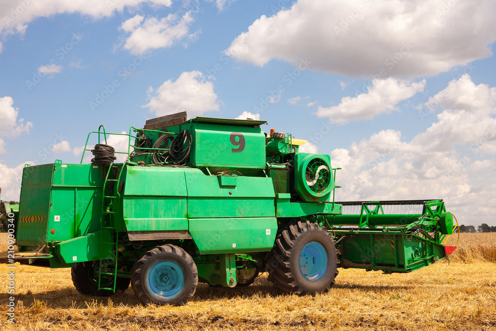 Krasnodar Territory, RUSSIA - July 08 2017 : Harvester machine to harvest wheat field working. Combine harvester agriculture machine harvesting golden ripe wheat field. Agriculture Krasnodar Territory, RUSSIA - July 08 2017 : Harvester machine to harvest wheat field working. Combine harvester agriculture machine harvesting golden ripe wheat field. Agriculture