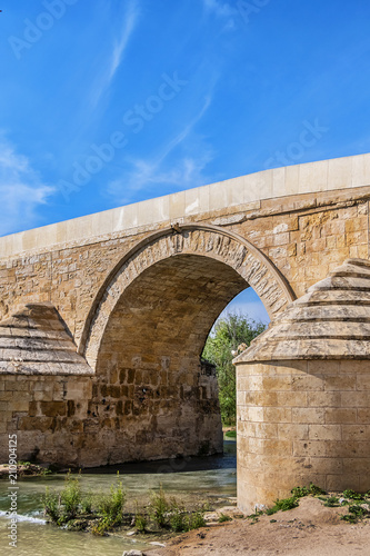 View of Roman bridge of Cordoba (1st century BC) across Guadalquivir River. Present structure of bridge dates from Moorish reconstruction in VIII century. Historic centre of Cordoba, Andalusia, Spain.