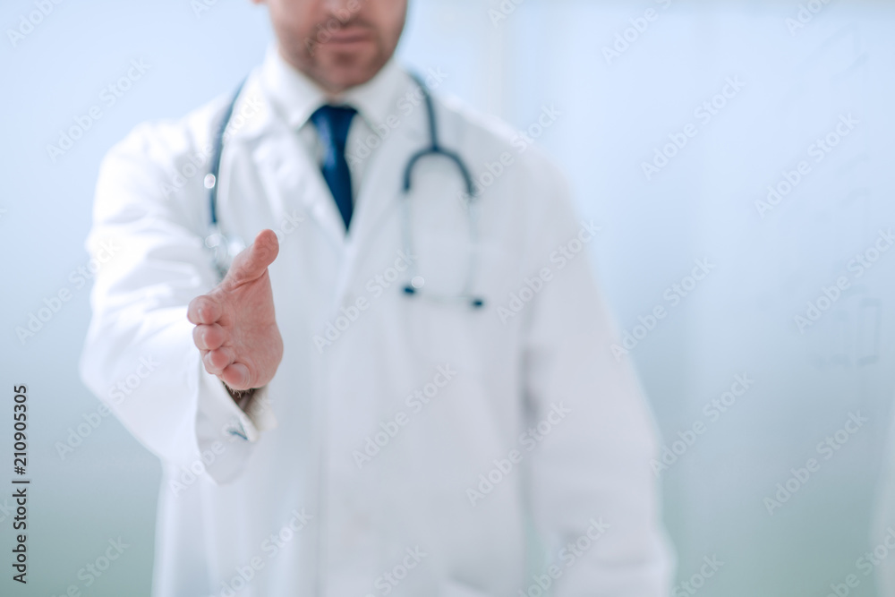 background image of the doctor holding out his hand for greeting