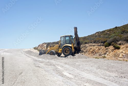 A bulldozer in the making of a road in a construction site