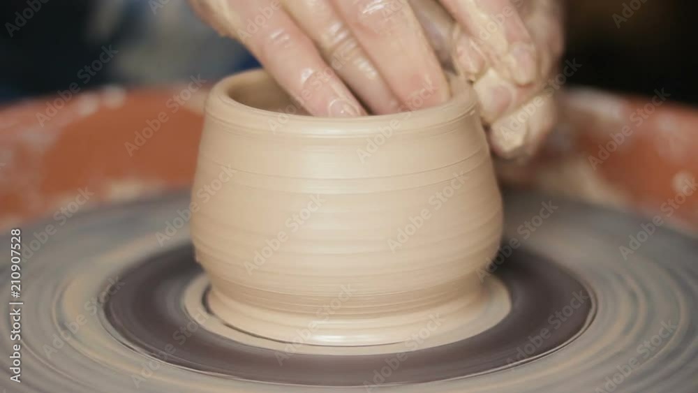 Experienced, industrious female hands, forming ceramic tureen on pottery wheel Experienced, industrious female hands, forming ceramic tureen on pottery wheel