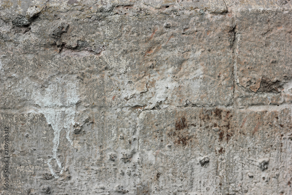 Gray old grungy textured concrete wall. Dirty painted stone background, city building wallpaper with place for text Gray old grungy textured concrete wall. Dirty painted stone background, city building wallpaper with place for text