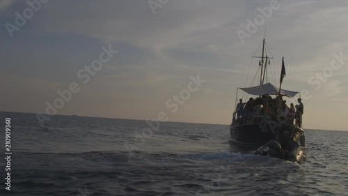 Sunsetting Behind a Boat In Ibiza photo