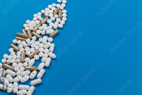 tablets and capsules on a blue background
