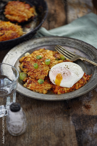 Root vegetables (parsnip, celeriac, sweet potato) pancakes with fried runny egg