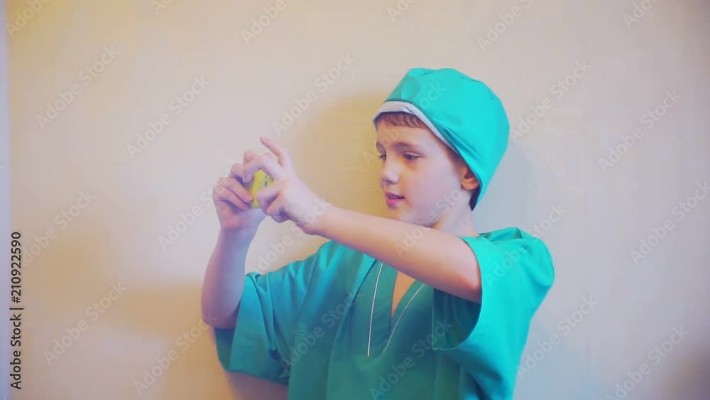 boy in doctor suit with a smartphone in the hands of boy in doctor suit with a smartphone in the hands of