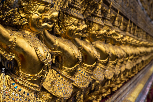 Photography Row of golden Garuda figures from Thai mythology, adorning the interior of Wat Phra Kaew (Temple of the Emerald Buddha)