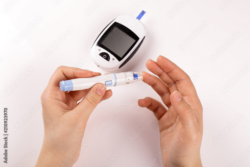 One person with diabetes doing a blood test with a glucometer isolated on white background
