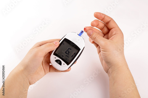 One person with diabetes doing a blood test with a glucometer isolated on white background