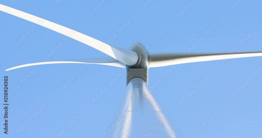 bottom view of wind turbine propeller blades rotating in slow motion power of nature renewable energy blue sunny sky on background new ecosystem technology repairing business electricity industry bottom view of wind turbine propeller blades rotating in slow motion power of nature renewable energy blue sunny sky on background new ecosystem technology repairing business electricity industry