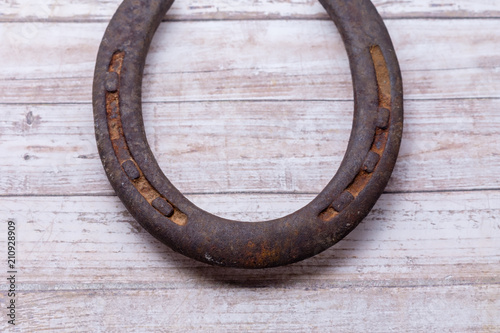 Rusty horseshoe on wood table with copy space