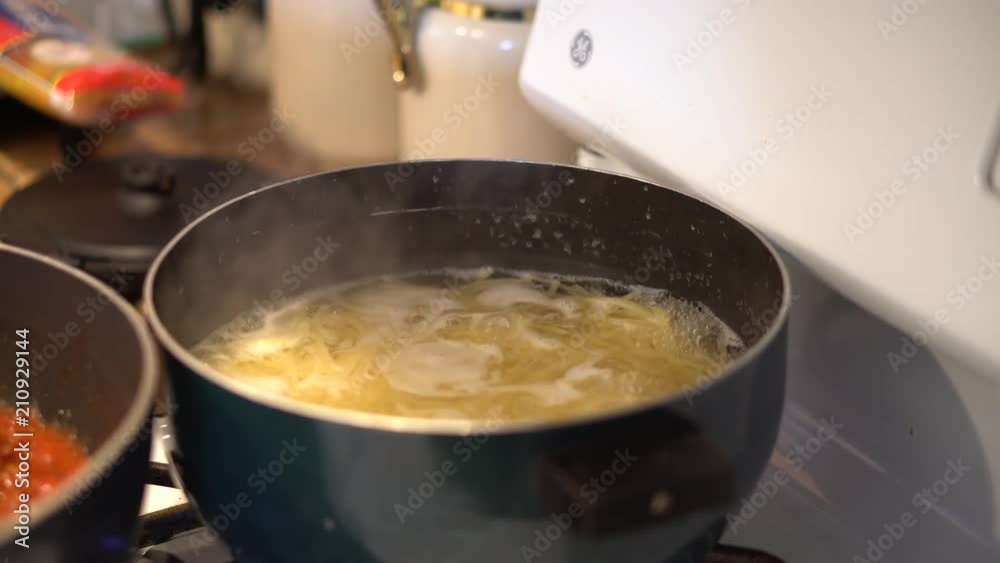 Noodles boil in a steaming pot, close-up Noodles boil in a steaming pot, close-up