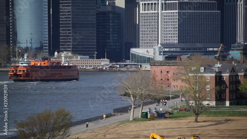 Ferry Passing Governors Island Shore NYC