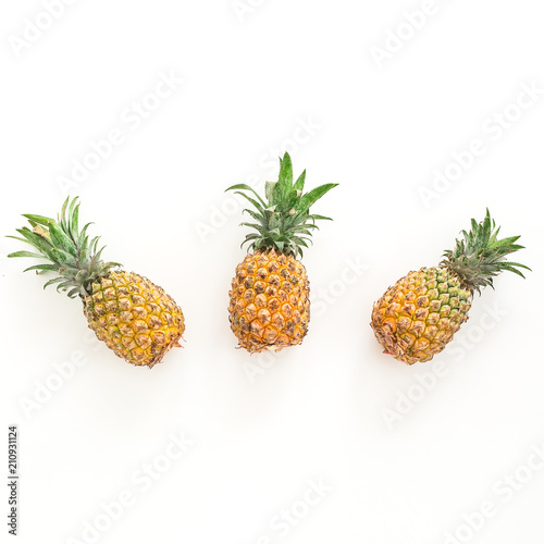 Food concept with pineapples on white background. Flat lay  top view.