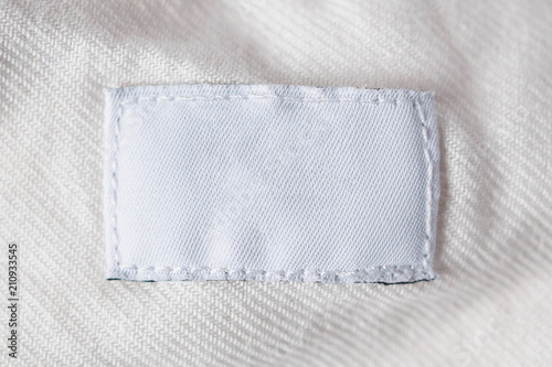 White blank laundry care clothes label on cotton shirt