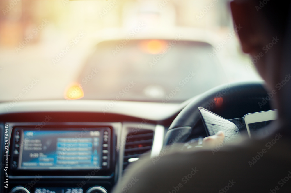 Man use smart phone in the car with the traffic jam. Man use smart phone in the car with the traffic jam.
