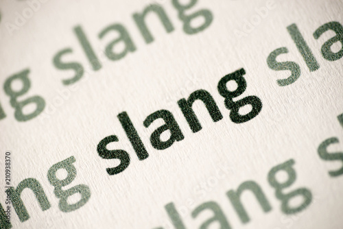 word slang printed on paper macro photo