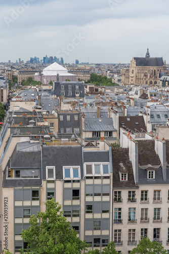 Paris, typical roofs and buildings in the center, with the Defense in background
