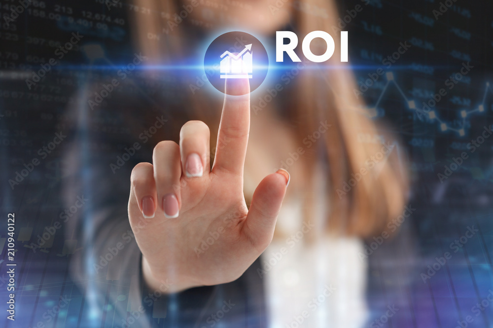The concept of business, technology, the Internet and the network. A young entrepreneur working on a virtual screen of the future and sees the inscription: ROI The concept of business, technology, the Internet and the network. A young entrepreneur working on a virtual screen of the future and sees the inscription: ROI