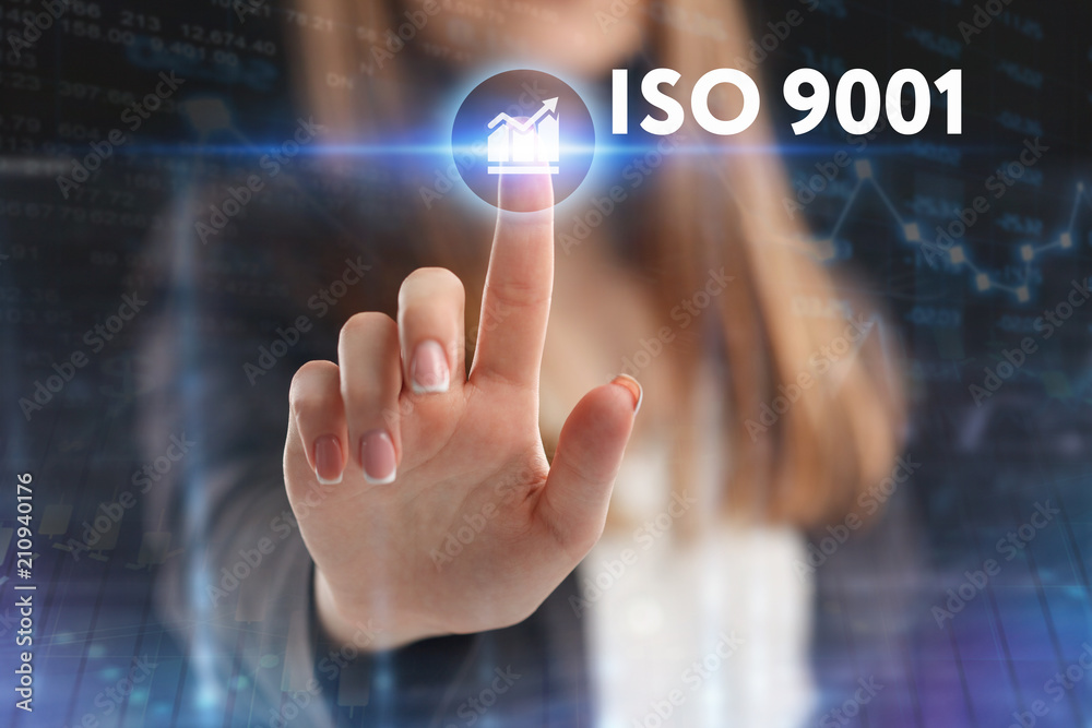 The concept of business, technology, the Internet and the network. A young entrepreneur working on a virtual screen of the future and sees the inscription: ISO 9001 The concept of business, technology, the Internet and the network. A young entrepreneur working on a virtual screen of the future and sees the inscription: ISO 9001