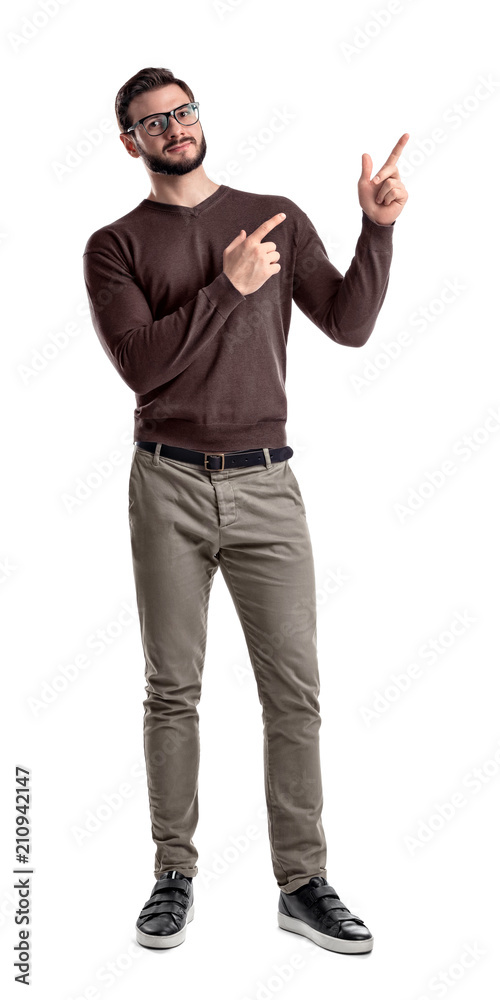 A bearded man in smart casual clothes looks in front to camera and points sideways with both hands and index fingers. A bearded man in smart casual clothes looks in front to camera and points sideways with both hands and index fingers.