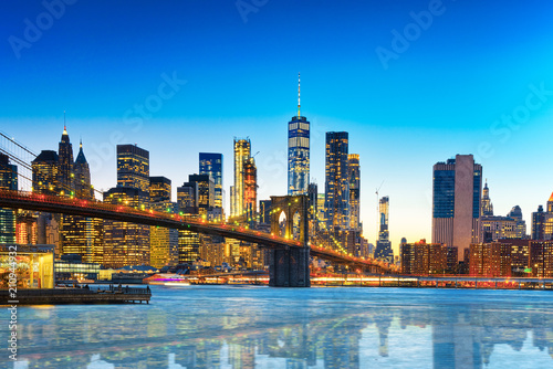 New York night view of the Lower Manhattan and the Brooklyn Bridge across the East River.