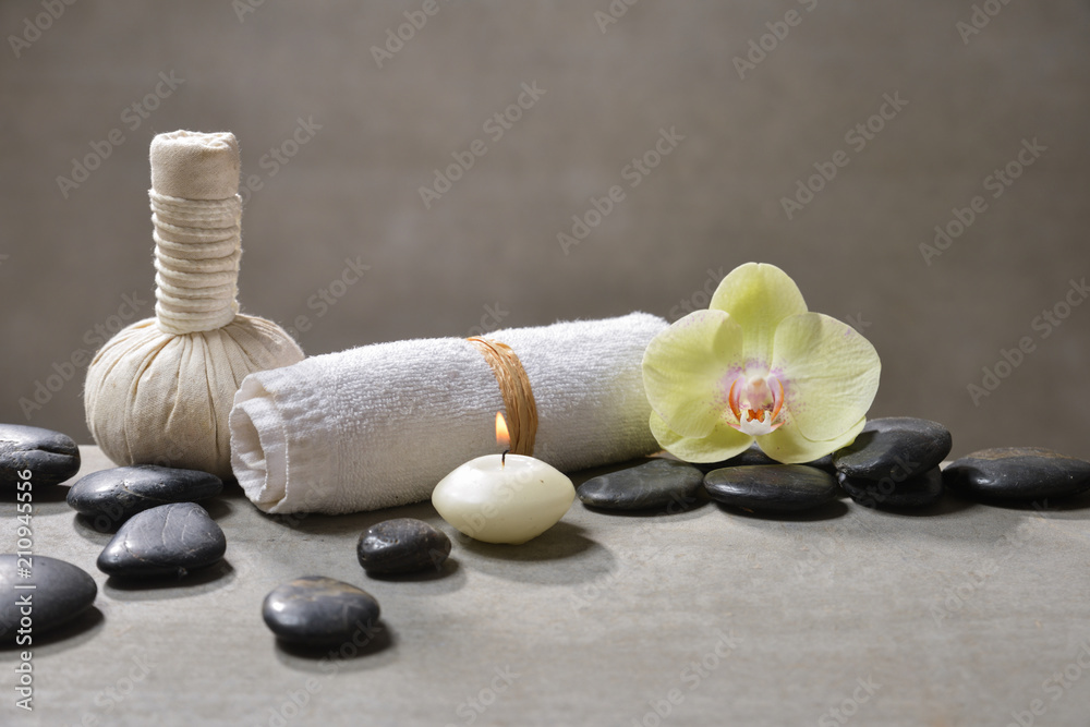 candle with pile of black stones and white frangipani, herbal ball.towel on gray background
candle with pile of black stones and white frangipani, herbal ball.towel on gray background