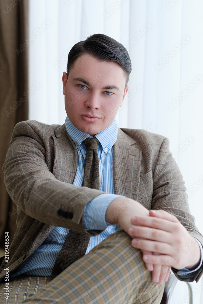 smug self satisfied business man with a smirk. successful corporate manager or chief executive sitting in office workspace smug self satisfied business man with a smirk. successful corporate manager or chief executive sitting in office workspace