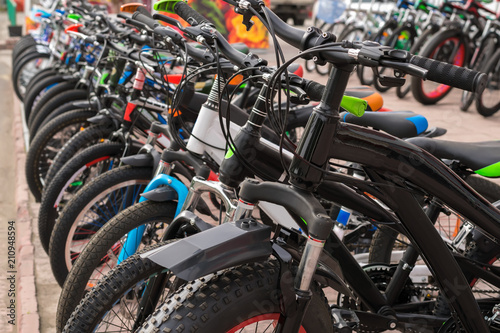 Parking of brand new teenager's bicycles on asphalt, sale