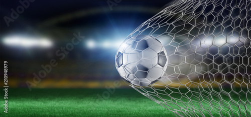 Football ball in the net of a goal - 3d rendering photo