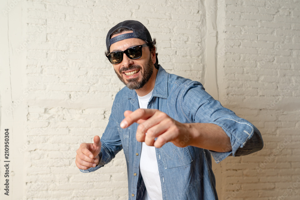 Naklejka premium young good looking latin man blogger talking to camera on white background