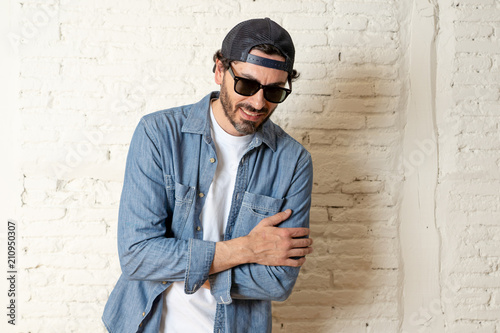 young good looking latin man blogger talking to camera on white background
