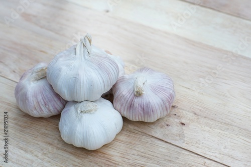 Fresh raw garlic on wooden table  copy space  kitchen raw ingredient concept