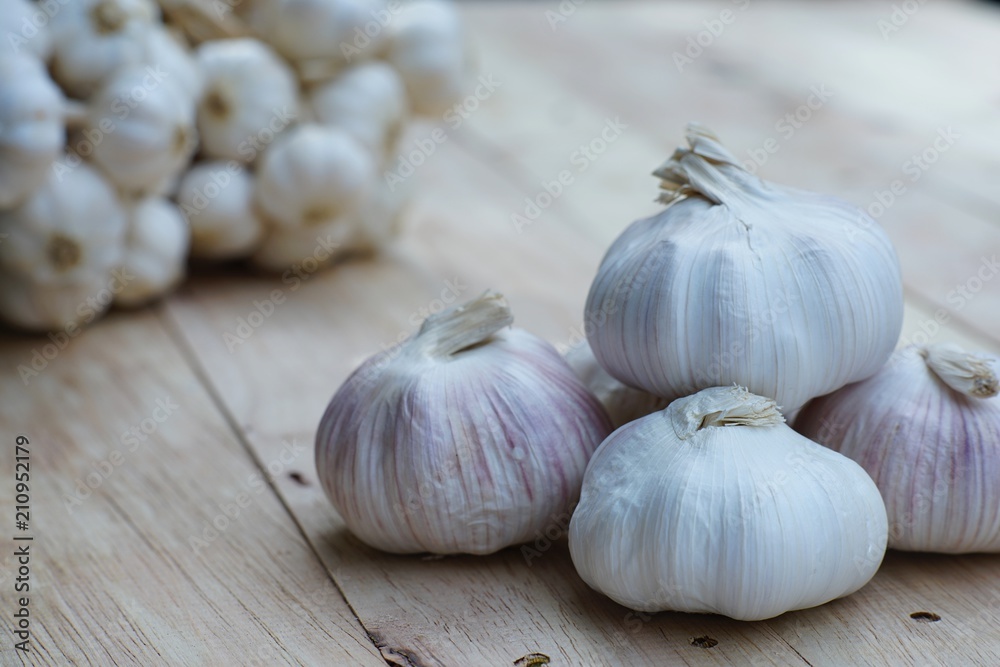 Fresh raw garlic on wooden table, copy space, kitchen raw ingredient concept Fresh raw garlic on wooden table, copy space, kitchen raw ingredient concept