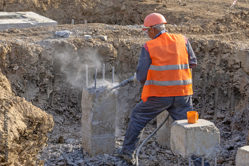 Builder with a jackhammer