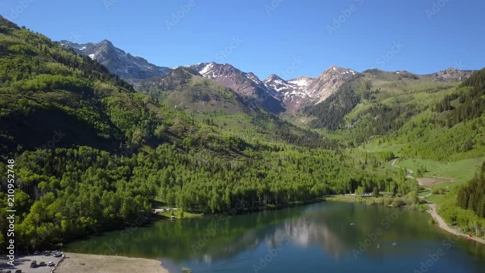 Aerial view flying over Sliver Lake Flats in the Utah mountains viewing the green forest. Aerial view flying over Sliver Lake Flats in the Utah mountains viewing the green forest.