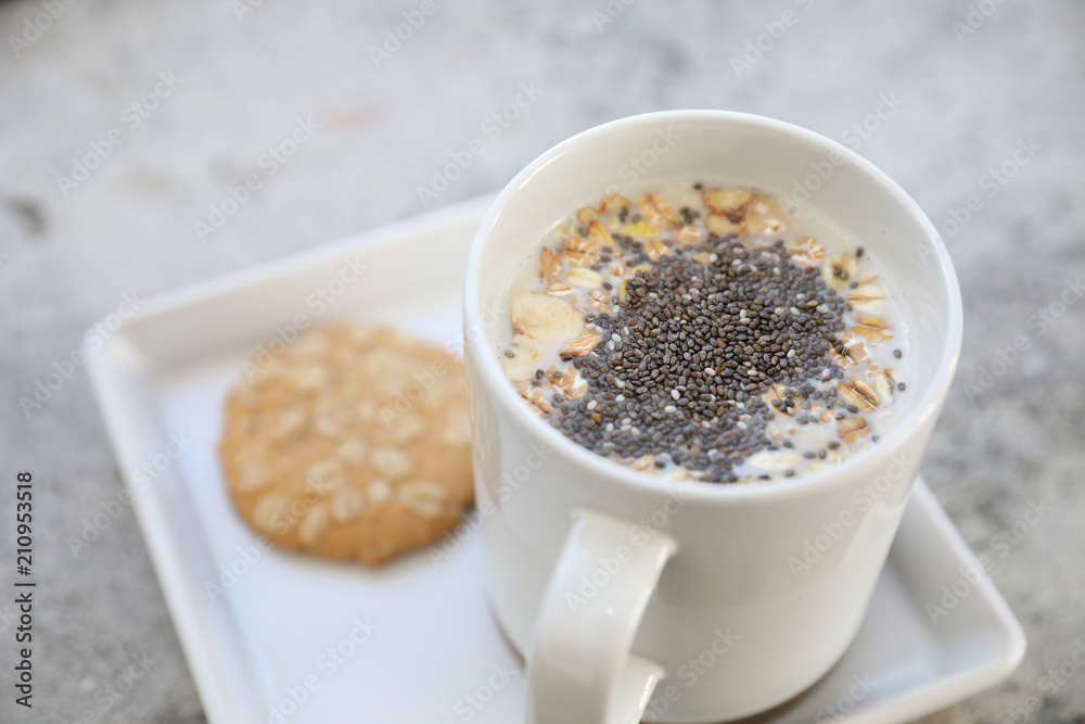 Cereal on milk in cup with woman hand breakfast Cereal on milk in cup with woman hand breakfast