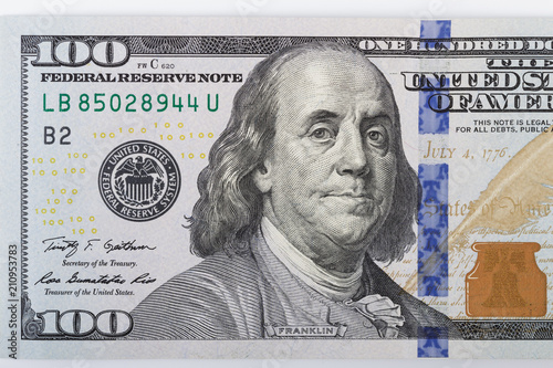 Macro shot of a 100 dollar. Dollars Closeup Concept. American Dollars Cash Money. One Hundred Dollar Banknotes. Hundred Bucks. Benjamin Franklin's portrait.