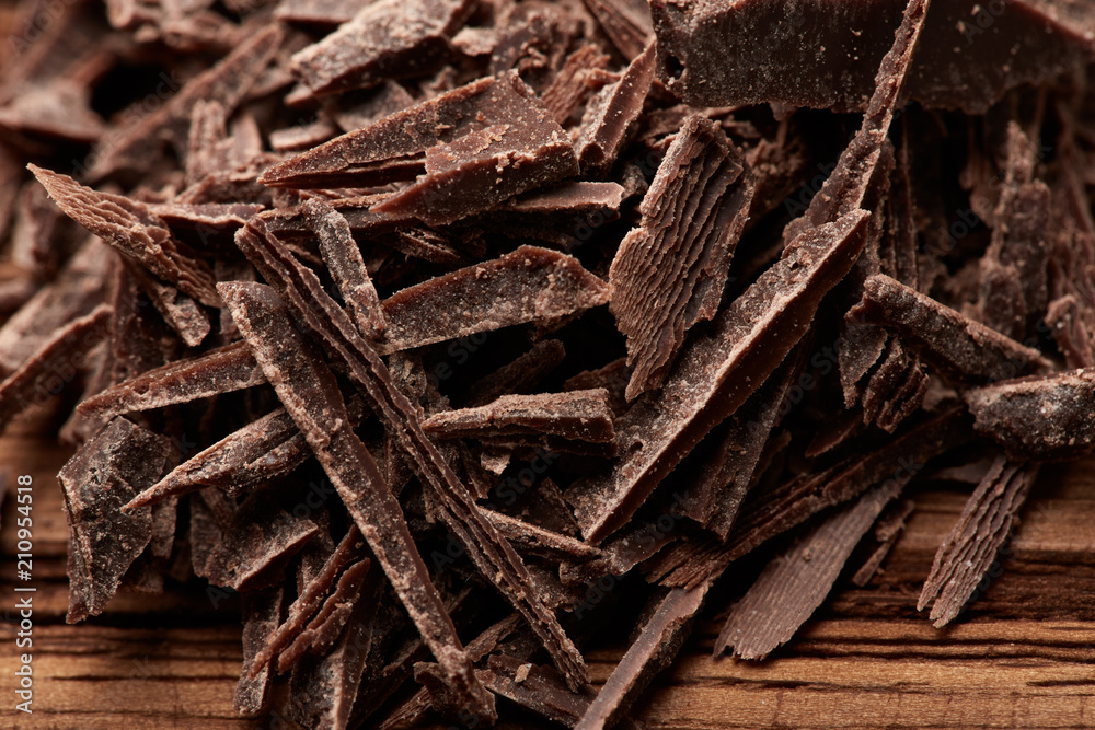 crumbs of black chocolate on a wooden background