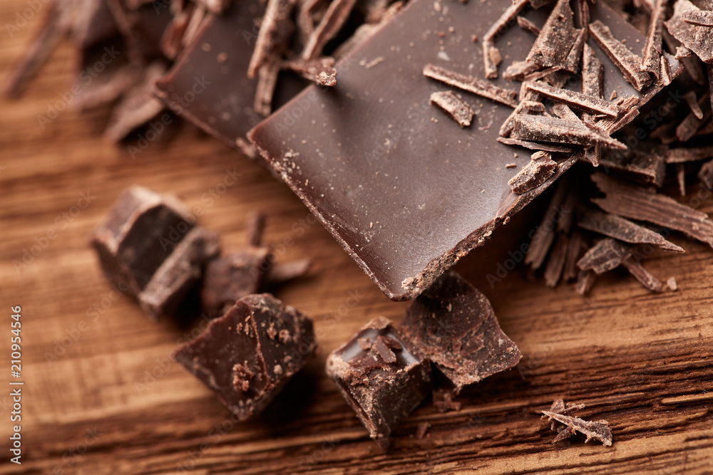 crumbs of black chocolate on a wooden background crumbs of black chocolate on a wooden background