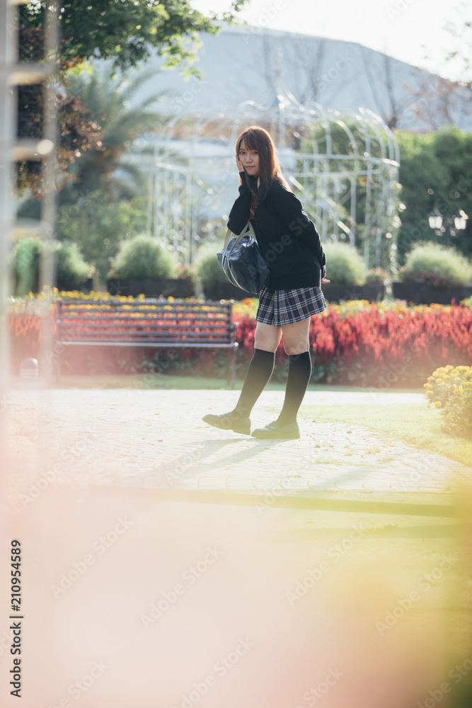 Portrait of asian japanese school girl costume looking at park outdoor
