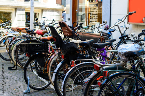 Bicycles parked on the city street on sunny day in Amsterdam, Th © smspsy