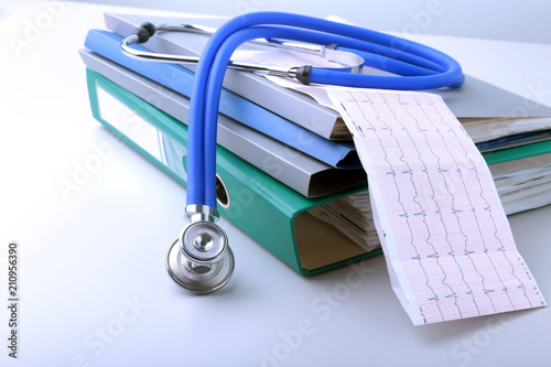 books folder file, stethoscope, red heart and RX prescription isolated on white background.