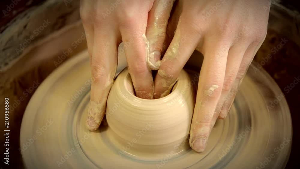Hands in the clay macro. Making Crock crude wet close-up. Man hands making clay jug macro. The sculptor in the workshop makes a jug out of earthenware closeup. Vase of white clay crude wet closeup Hands in the clay macro. Making Crock crude wet close-up. Man hands making clay jug macro. The sculptor in the workshop makes a jug out of earthenware closeup. Vase of white clay crude wet closeup