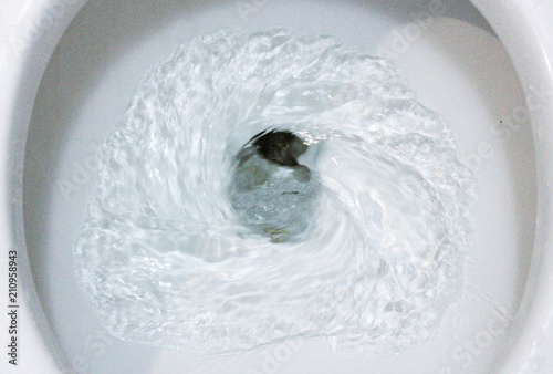 selective focus close up flushing toilet bowl for sanitary, Toilet, Flushing Water, close up, water flushing in toilet, A photo of a white ceramic toilet bowl in the process of washing it off. Ceramic © Am.p Photographer