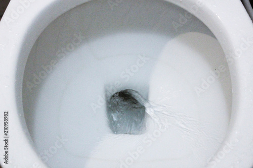 selective focus close up flushing toilet bowl for sanitary, Toilet, Flushing Water, close up, water flushing in toilet, A photo of a white ceramic toilet bowl in the process of washing it off. Ceramic