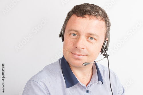 man Customer service representative wearing headset at the office