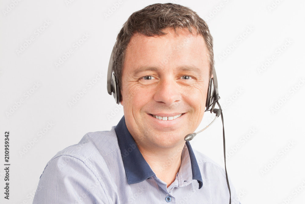 man working smiling with headset in a call center man working smiling with headset in a call center